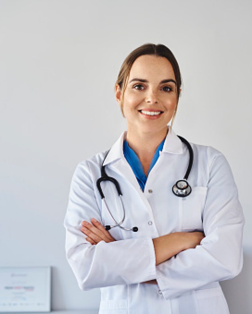 Portrait of smiling female doctor wearing uniform standing